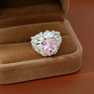 Detailed close-up of a luxury pink cushion-cut zirconia ring in a brown velvet jewelry box