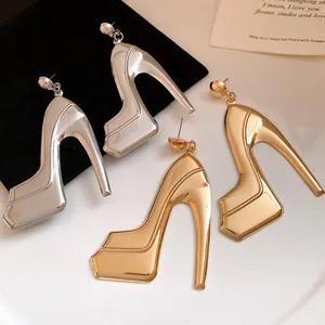 Detailed macro shot of vintage high heel pendant earrings with glossy metallic finish
