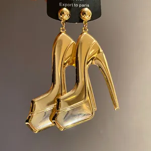 Macro detail of high-shine gold high-heel earrings with metallic finish
