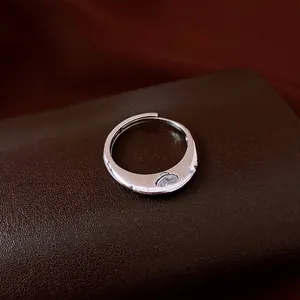 Vintage silver wavy open ring with sparkling zircon stone on brown leather base