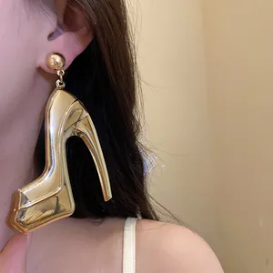 Detailed close-up showing the metallic gold high heel pendant earring on model
