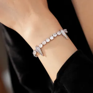 Close-up detail of punk style silver zircon bracelet with round and rhombus spikes on wrist