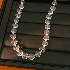 Detailed macro view of transparent heart crystal beads on a black jewelry display tray