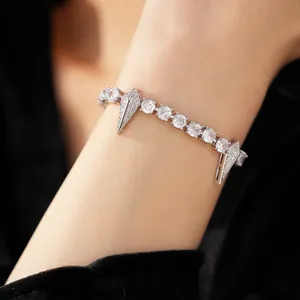 Close-up view of hip-hop punk zircon bracelet with diamond charms on model wrist