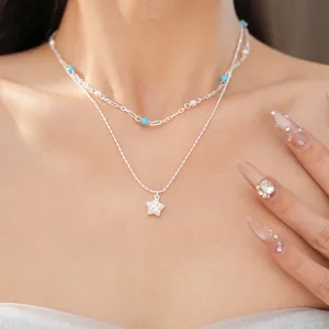 Double layered silver necklace with turquoise beads, pearls and a sparkling star pendant.
