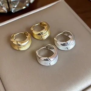 Elegant pair of 18K gold and silver plated hoop earrings with textured brushed finish