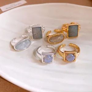 Detailed macro shot of 18k gold plated adjustable open rings with various stone shapes