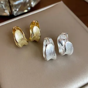 Premium 18K gold plated brushed texture hoop earrings set in gold and silver tones.