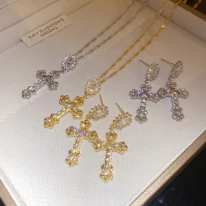 Exquisite close-up of 18k gold plated cubic zirconia cross necklace and earring sets