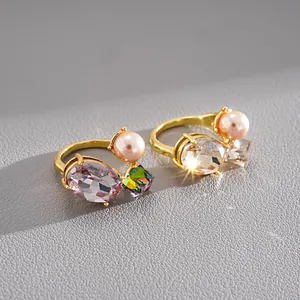 Detailed close-up of luxury gold open rings with faux pearls and faceted crystals