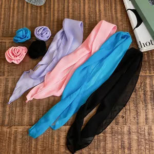 Detailed view of sweet chiffon flower hair clips and matching skinny scarves in various colors.