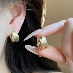 Brushed 18k gold plated circular huggie hoop earrings with elegant minimalist design