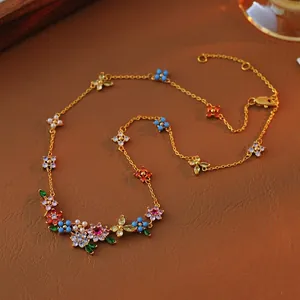 Detail view of an 18k gold-plated flower bracelet with colorful zircons and pearls.