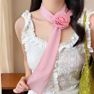Detail shot of elegant pink chiffon scarf necklace with large rose flower decoration