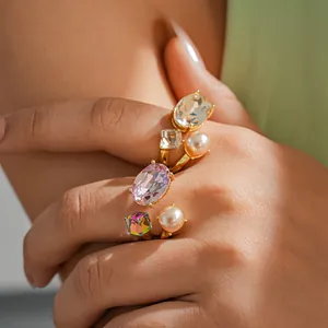 Detailed view of luxury open ring featuring faux pearls and oval pink crystals