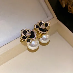 Elegant 14k gold plated flower stud earrings with white pearls and pavé zircons