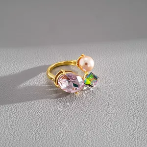 Detailed close-up view of the luxury open ring with pink oval crystal and faux pearl accent
