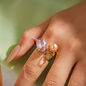 Luxury open ring detail featuring pink oval crystal, square green stone and elegant faux pearl