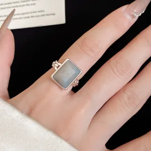 Detailed view of an 18k gold-plated rectangular stone open ring on finger