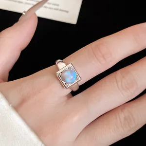 Close-up detail of an elegant 18k gold plated square open ring with a blue moonstone