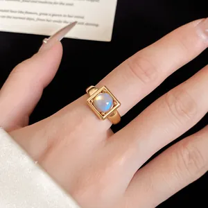 Detailed view of an 18k gold plated minimalist ring with a square frame and stone
