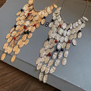 Vintage metal tassel necklace with textured oval charms and colorful agate beads