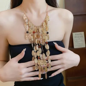 Vintage gold pleated metal tassel necklace with agate beads worn by model.