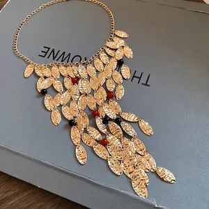 Vintage style gold hammered oval plate fringe necklace with red and black agate beads accents