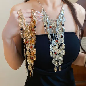 Detailed macro view of retro palace style wrinkled metal tassel necklace with agate beads