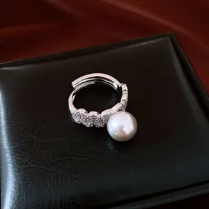 Elegant adjustable silver-toned lace ring with micro-pavé diamonds and a lustrous white pearl