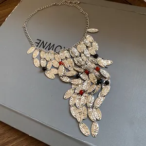Detailed view of vintage silver textured oval tassel necklace with red agate beads