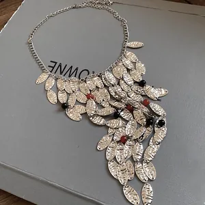 Close-up of vintage silver leaf tassel necklace with agate bead accents