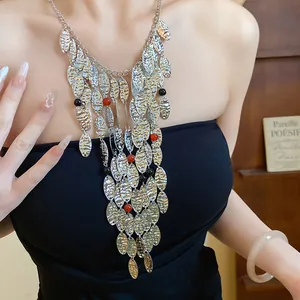 Detailed macro view of vintage metal wrinkled oval fringe necklace with agate beads