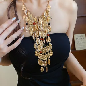 Detailed view of vintage gold pleated oval metal necklace with agate bead tassels