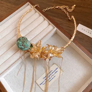 Vintage gold floral choker necklace with green snail shell and tassel chains