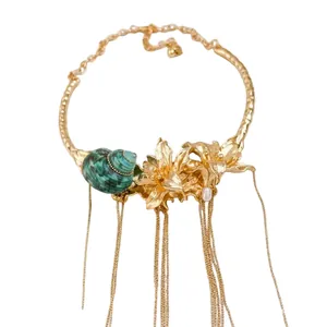 Elegant vintage gold choker featuring floral seashell design and hanging tassels.