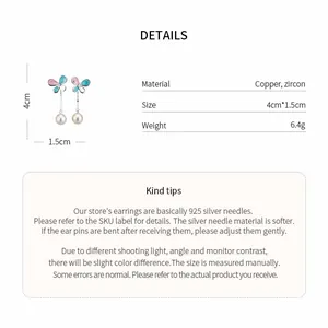 Macro detail of colorful butterfly tassel earrings with 925 silver needle and pearls.