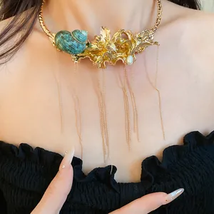 Close-up of vintage gold flower and shell choker with elegant dangling tassels