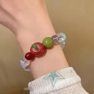 Close-up of sweet resin apple beaded bracelet with colorful stone beads