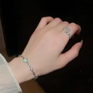 Elegantes Set aus funkelndem Blumenarmband und Ring mit Zirkonia-Inlay