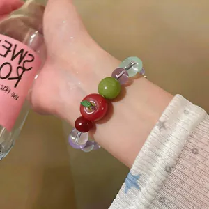 Detailed shot of a sweet apple beaded bracelet featuring colorful resin and stone beads