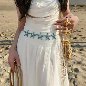 Detailed view of starfish necklaces with pearls and rhinestones in a beach setting