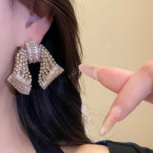 Close-up view of sparkling zircon bow stud earrings for an elegant statement look.