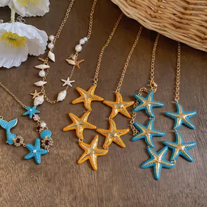 Detailed view of ocean-themed necklaces with enamel starfish, pearls, and shell charms.