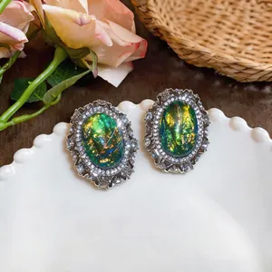 Vintage court style oversized oval resin earrings with crystal-encrusted silver frame