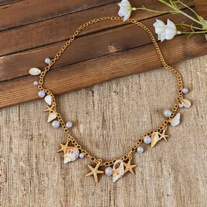 Detailed view of a gold starfish and seashell pearl necklace on a beach-themed background.