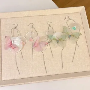 Dreamy butterfly shell tassel drop earrings with iridescent finish and chiffon flowers