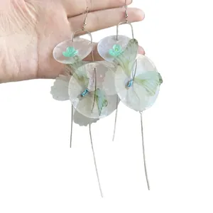 Dreamy butterfly shell tassel earrings with iridescent petals and long silver fringe