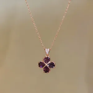 Detailed close-up of a rose gold necklace featuring a purple water-drop zircon flower pendant