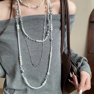 Detailed view of a French vintage 4-piece pearl and cross beaded jewelry necklace set.